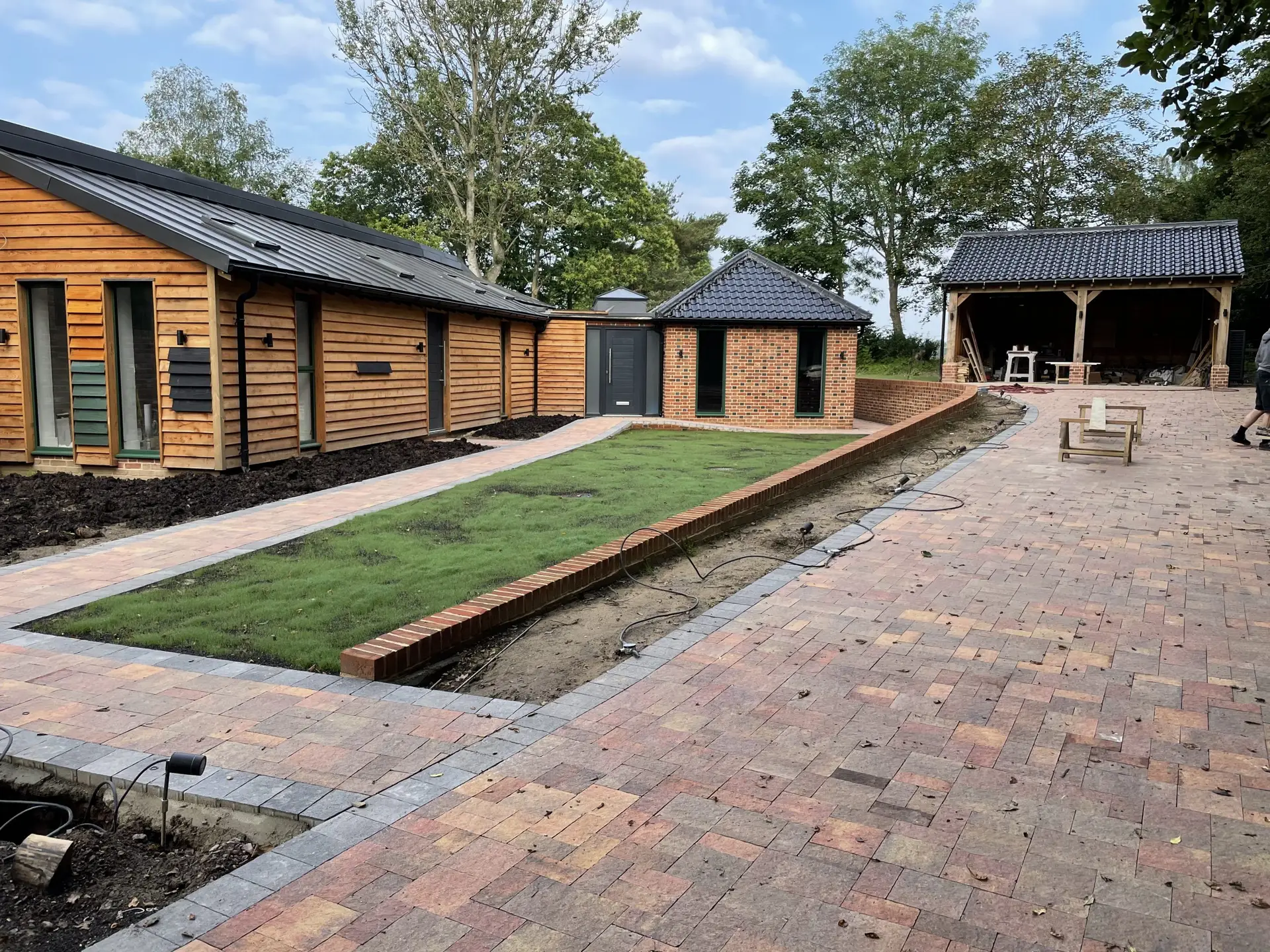 High-end new homes in Tenterden Kent featuring traditional red brickwork and Kentish weatherboarding.