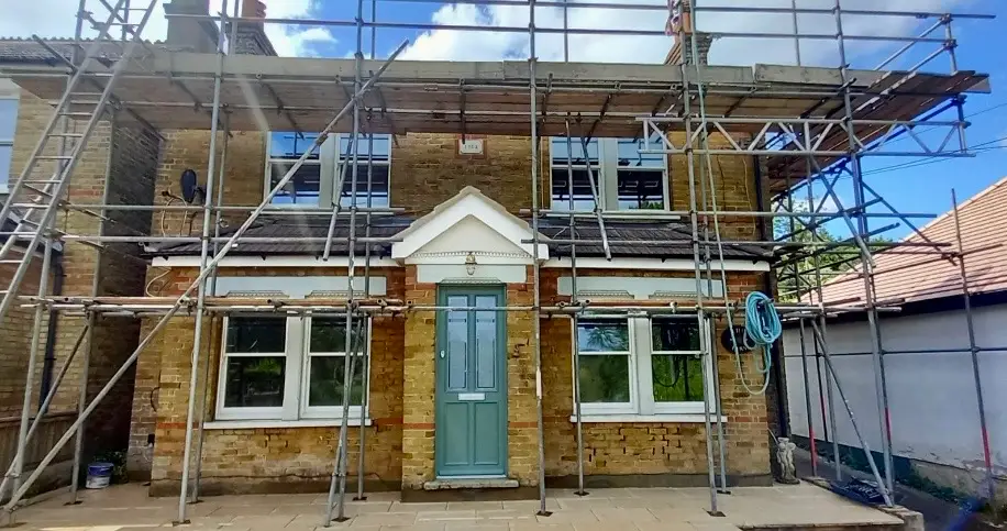 Traditional listed brick cottage in Kent during a wet winter